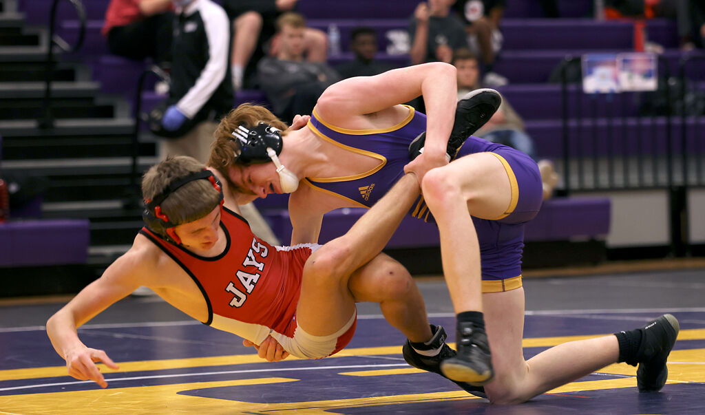 Hickman's Hayden Benter takes down Eli Tiberius on Tuesday at Hickman High School in Columbia.